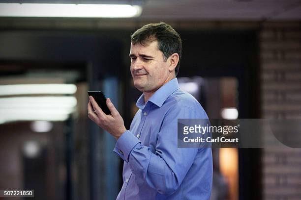 Former City broker Darrell Read smiles while checking his phone as he leaves after being cleared of helping to rig the Libor lending rate at...