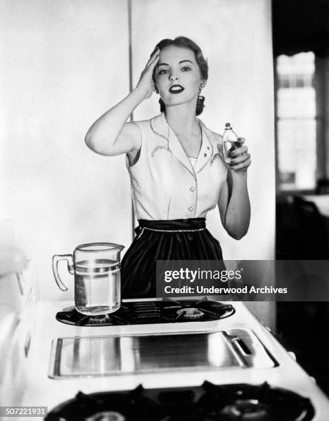 In a photograph from the Fragrance Foundation, 'Despite the heat from the stove in the summertime, this young homemaker will appear crisp and pretty...