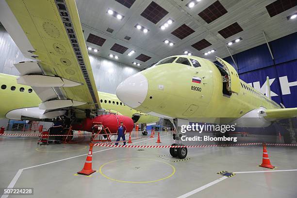 Russian national flag sits beneath the cockpit on the fuselage nose section of a Sukhoi Superjet 100 aircraft during construction at the Sukhoi Civil...