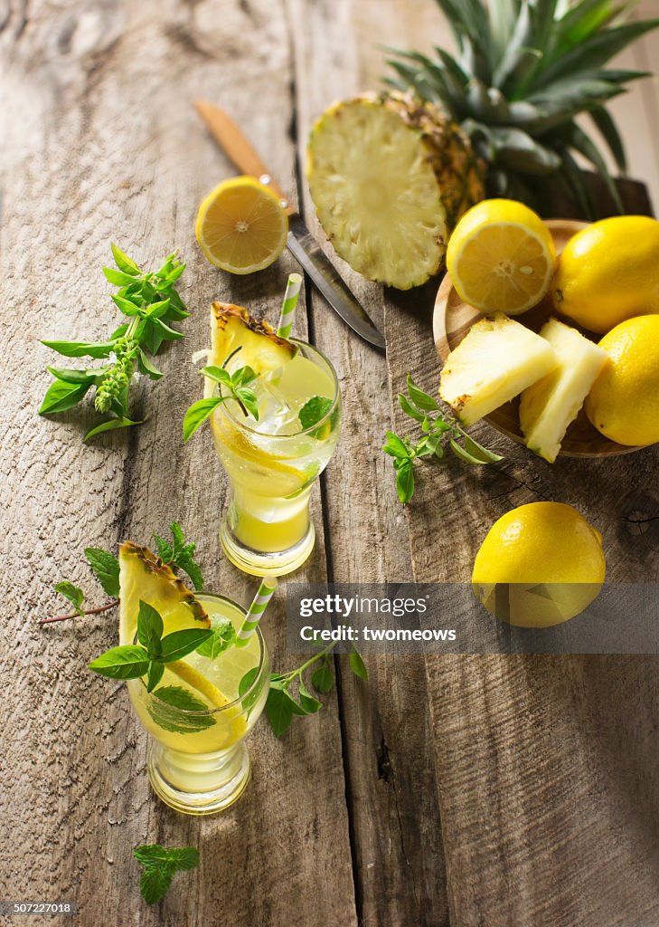 Fresh pineapple and lemon juice with fresh mint and basil leaf.