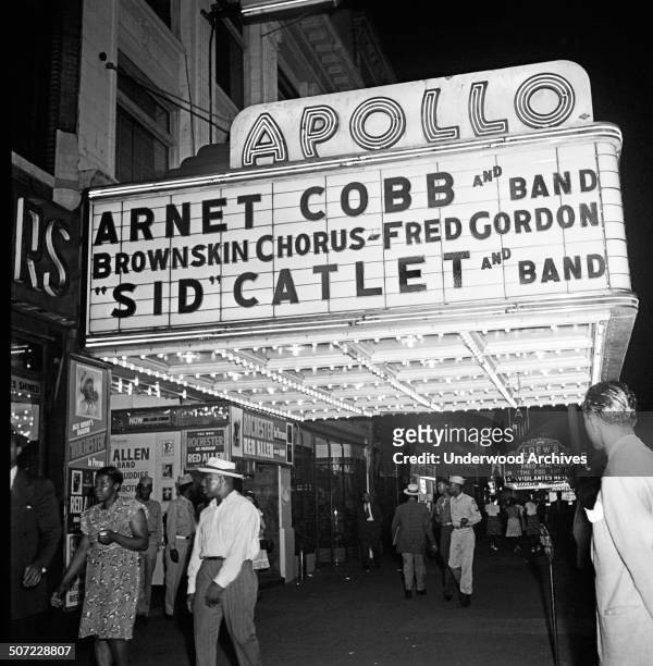 View of the Apollo Theatre marquee at night on West 125th Street in Harlem, New York, New YorK, 1947.