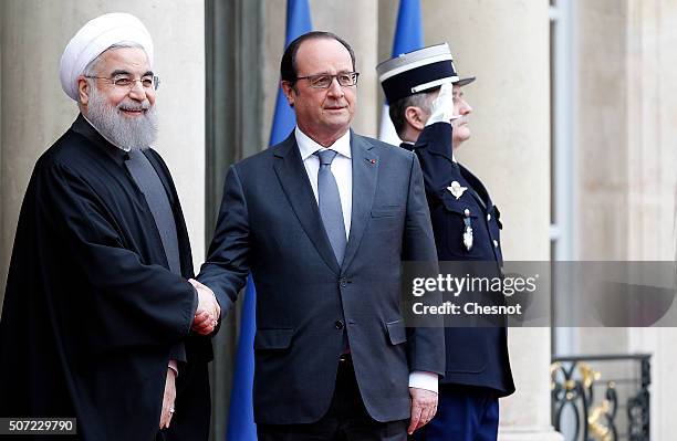 French President Francois Hollande welcomes Iranian President Hassan Rouhani prior to attend a meeting at the Elysee Presidential Palace on January...
