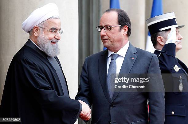 French President Francois Hollande welcomes Iranian President Hassan Rouhani prior to attend a meeting at the Elysee Presidential Palace on January...