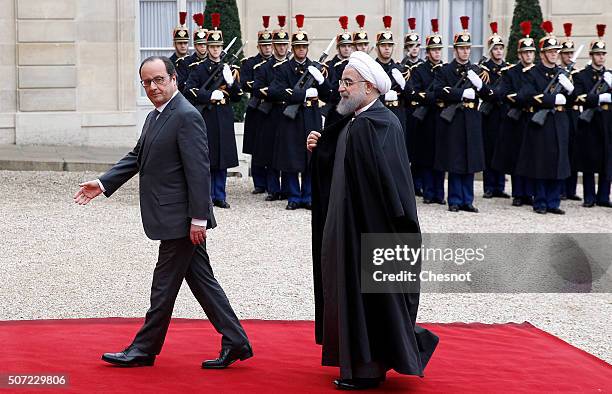 French President Francois Hollande welcomes Iranian President Hassan Rouhani prior to attend a meeting at the Elysee Presidential Palace on January...