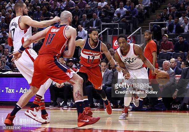 DeMar DeRozan of the Toronto Raptors dribbles past Garrett Temple of the Washington Wizards during an NBA game at the Air Canada Centre on January...