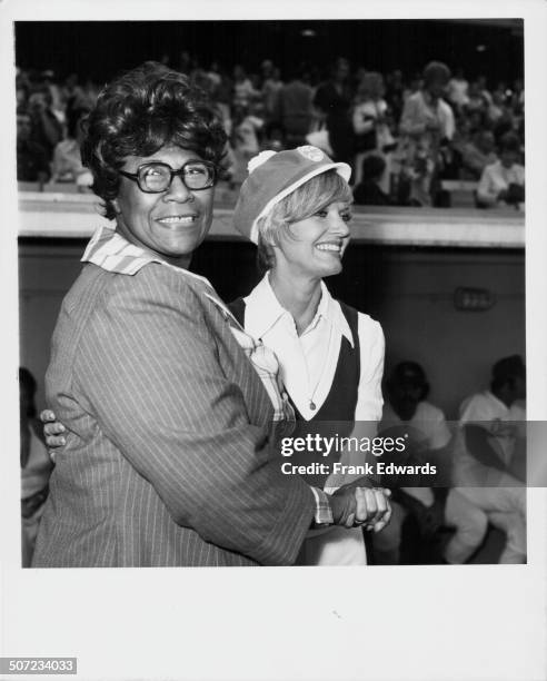 Singer Ella Fitzgerald cheering on her fellow celebrities during a charity baseball game, with Florence Henderson, August 1973.