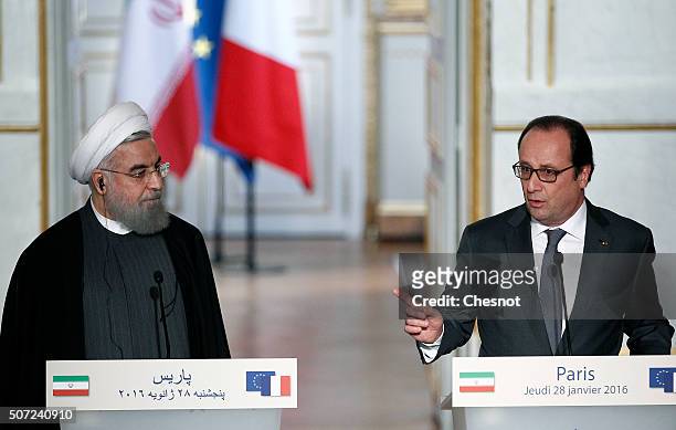 French President Francois Hollande delivers a speech next to Iranian President Hassan Rouhani during a press conference at the Elysee Presidential...