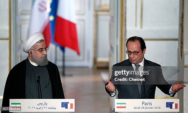 French President Francois Hollande delivers a speech next to Iranian President Hassan Rouhani during a press conference at the Elysee Presidential...