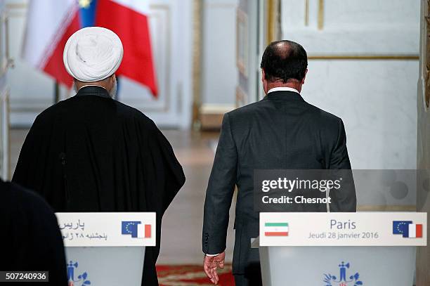 Iranian President Hassan Rouhani and French President Francois Hollande leave after a press conference at the Elysee Presidential Palace on January...