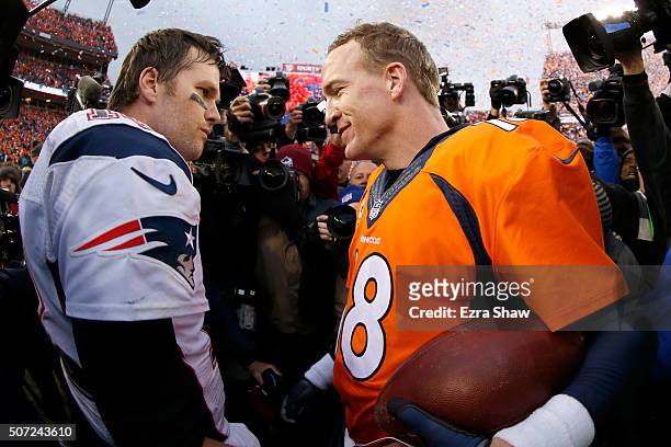 Peyton Manning of the Denver Broncos and Tom Brady of the New England Patriots speak after the AFC Championship game at Sports Authority Field at...