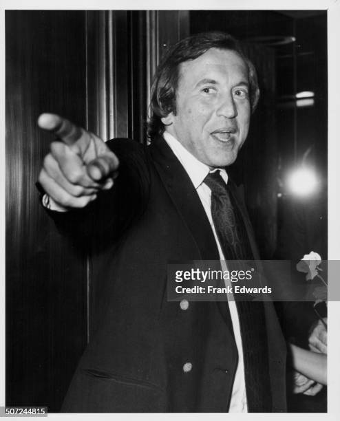 Broadcaster and journalist David Frost pointing at someone off-camera, attending a dinner honoring singer Jane Morgan Weintraub as 'Mother of the...