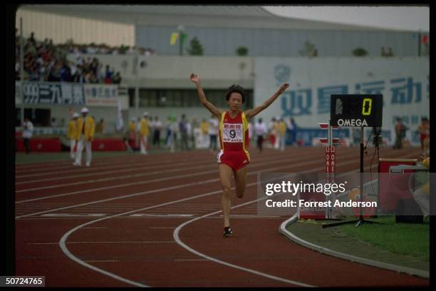 View of Chinese long-distance runner, track athlete Wang Junxia as she competes in the Women's 10,000 meter race during the Chinese National Games,...