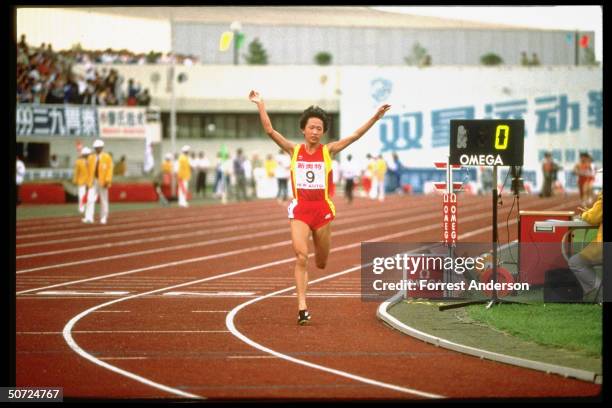 View of Chinese long-distance runner, track athlete Wang Junxia as she competes in the Women's 10,000 meter race during the Chinese National Games,...