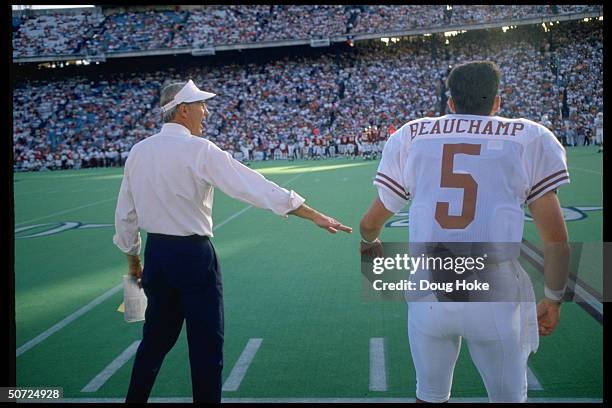 Portrait of Texas Longhorns Beauchamp w. Coach John Mackovic on the sidelines.