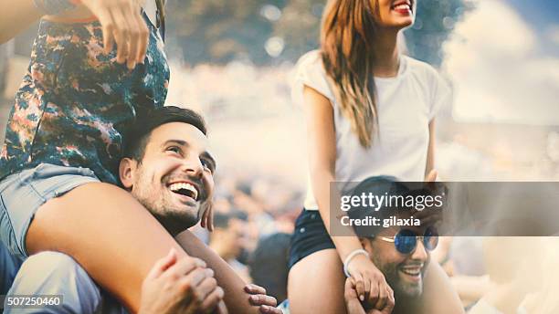 people enjoying a concert. - carrying on shoulders stock pictures, royalty-free photos & images