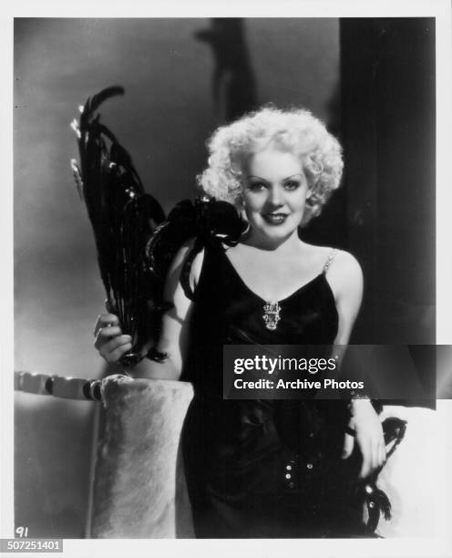 Actress Alice Faye, wearing an evening dress with feathered plume, as she appears in the movie 'Now I'll Tell', 1934.