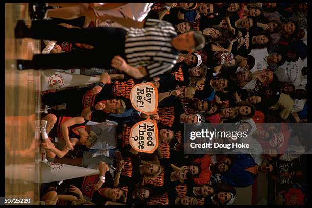 Oaklohoma St. Fans, one w. Large cut-out glasses.; Glasses read: HEY REF! NEED THESE? Fans wearing t-shirts reading: YOUNG GUNS.;