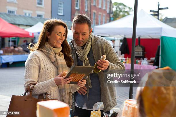 couple visit local food market - english village stock pictures, royalty-free photos & images