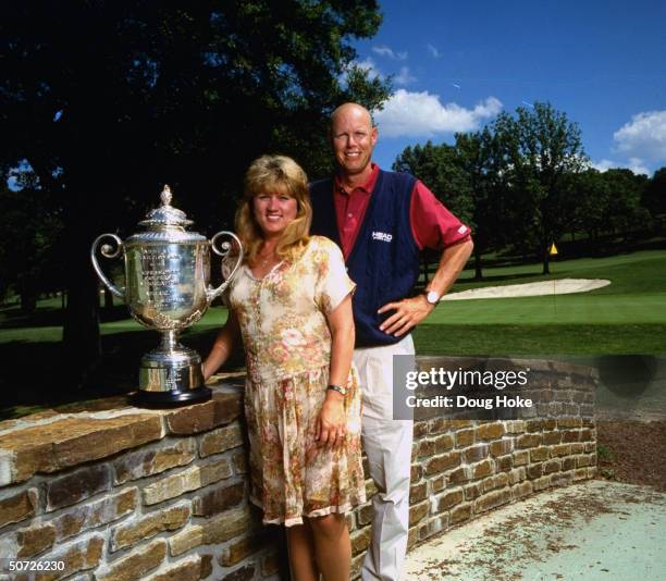 Feature. Portrait of Paul Azinger w. Wife, Toni & PGA Championship trophy.; Azinger bald after chemotherapy treatments.;