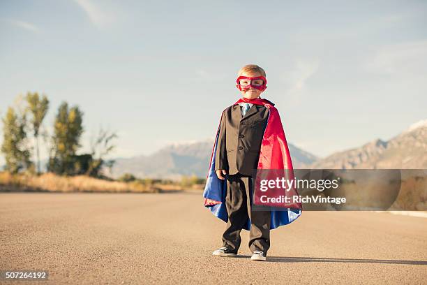 young boy wearing superhero costume and business suit - super excited suit stock pictures, royalty-free photos & images