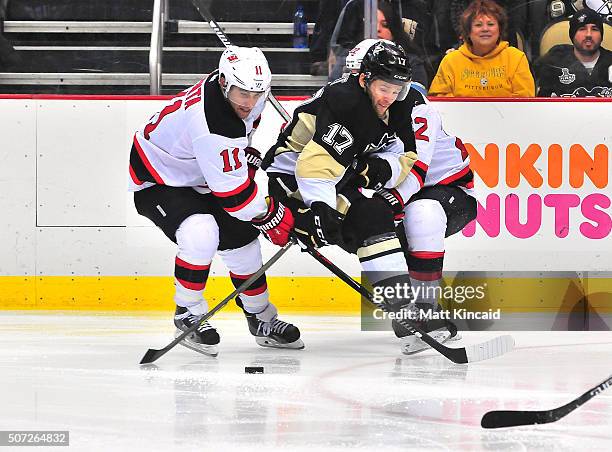 Bryan Rust of the Pittsburgh Penguins skates with the puck against the New Jersey Devils at Consol Energy Center on January 26, 2016 in Pittsburgh,...