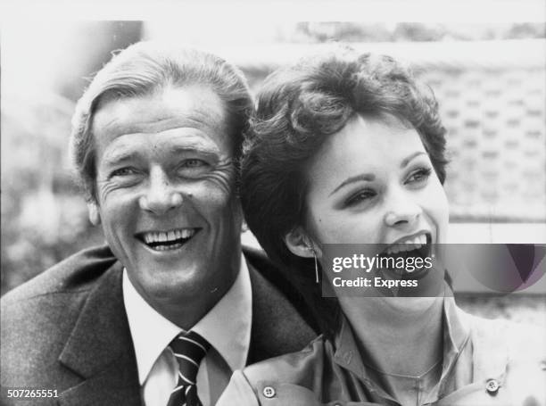 Actor Roger Moore and singer Sheena Easton posing together, to promote the film 'For Your Eyes Only', and the song of the same name, 1981.