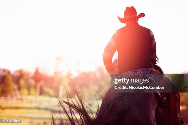 cowboy riding away rear view - man on horse back stock pictures, royalty-free photos & images