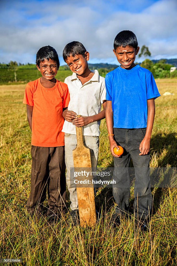 Young Sri Lankan boys playing cricket on tea plantation