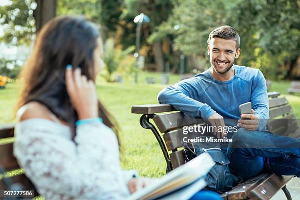 girl and boy flirting - flirten stockfoto's en -beelden