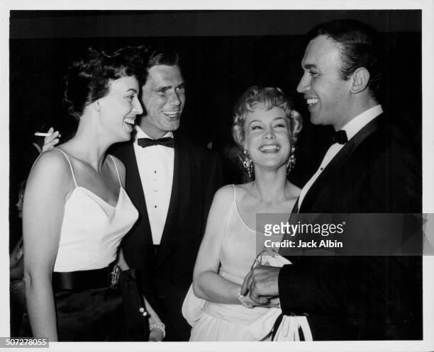 Actor John Lupton and his wife, with actors Mike Ansara and Barbara Eden, at at event at the Hilton Hotel, Los Angeles, circa 1965.