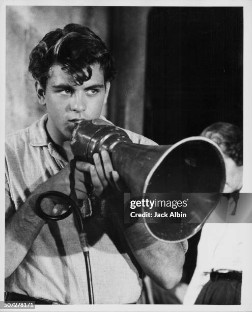 Actor Fabian Forte, talking into a loud hailer on a film set, circa 1960.