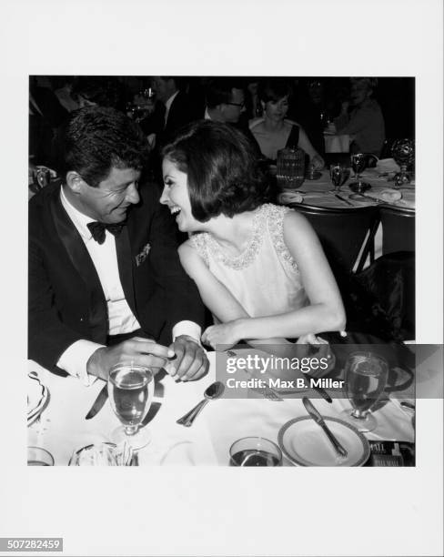 Musician Eddie Fisher and actress Barbara Parkins laughing together at singer Bobby Darin's Cocoanut Grove opening performance, Los Angeles, CA,...