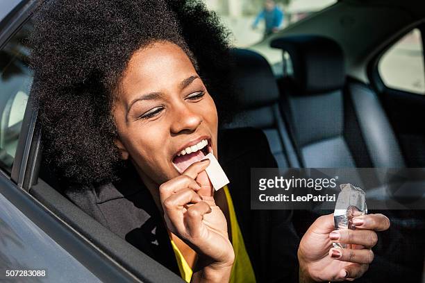 woman eating chewing gum on a road trip - gum stock pictures, royalty-free photos & images