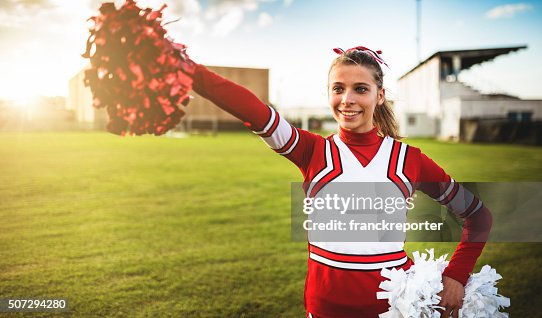 Happiness cheerleader posing with pon-pon Happiness cheerleader posing with pon-pon