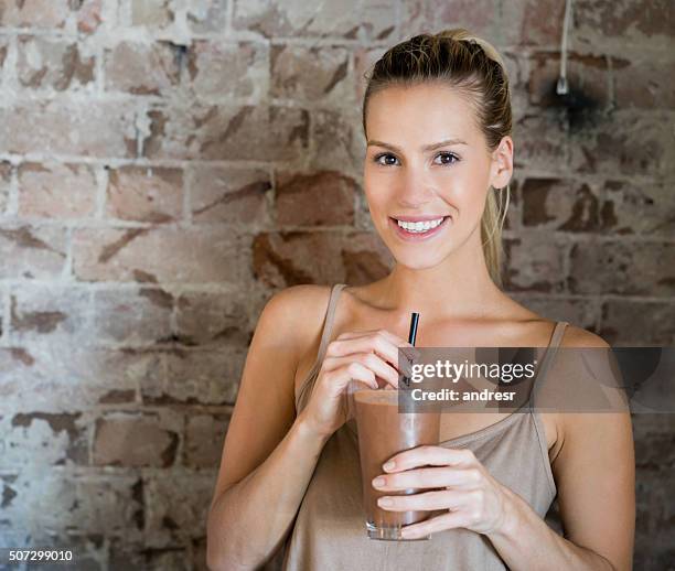 woman having a milkshake - chocolate smoothie bildbanksfoton och bilder