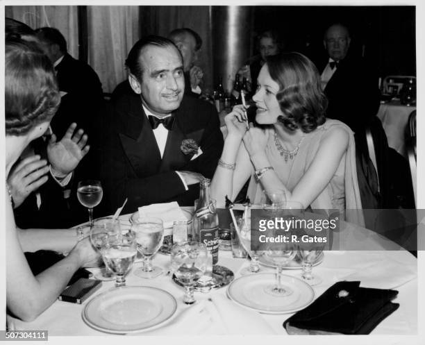 Actor Douglas Fairbanks and his wife, Lady Sylvia Ashley, sitting at table together at an event, circa 1937.