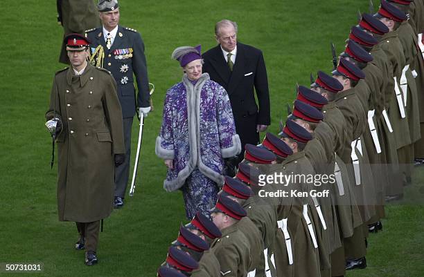 Queen Margrethe of Denmark followed by England's Prince Philip inspecting the guard of honor at Windsor Castle during 3-day State Visit to the UK by...
