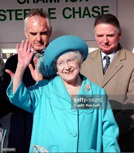 England's Queen Mother acknowledges the cheers from the crowds at the Cheltenham National Hunt meeting.