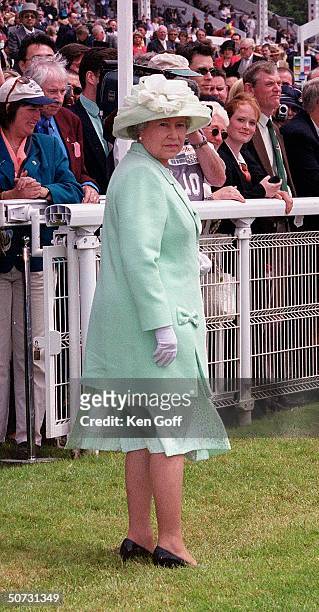 Queen Elizabeth waiting as unseen Queen Mother makes way to enclosure at the Epsom Derby.
