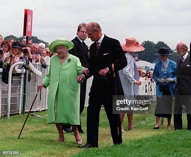 Queen Mother being helped by Prince Philip as she makes way to enclosure at the Epsom Derby.