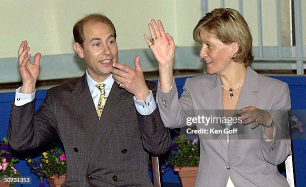 England's Prince Edward & wife Sophie playing out the actions to a children's song at the Connaught Junior School in Bagshot, where they were opening...