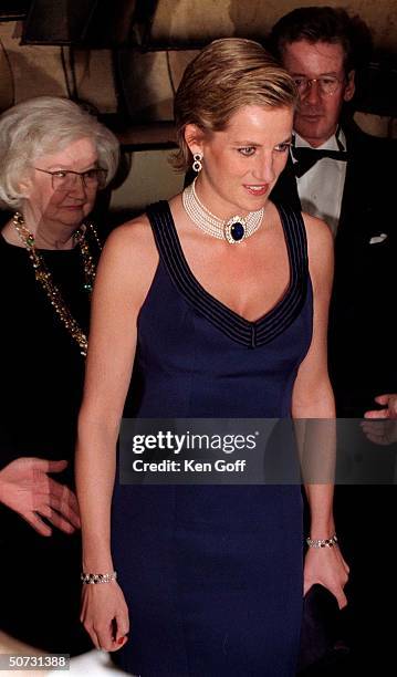 England's Princess Diana in a new sleek hairstyle, jeweled choker & navy blue strapped gown at a charity gala dinner at the Lincoln Center for the...