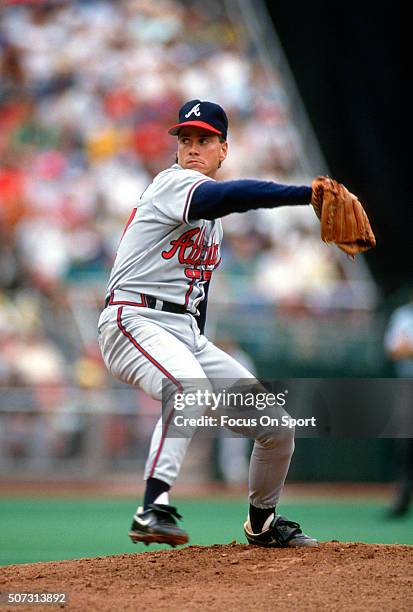 Tom Glavine of the Atlanta Braves pitches against the Philadelphia Phillies during a Major League Baseball game circa 1990 at Veterans Stadium in...