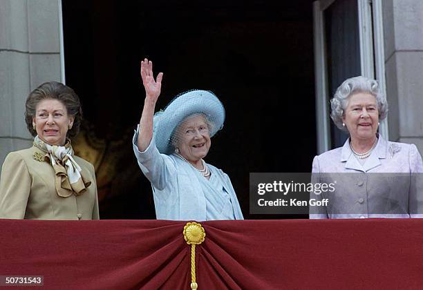 Britain's Queen Mother in blue hat and dress celebrating her 100th birthday w. Daughters Princess Margaret in brown and Queen Elizabeth II in...