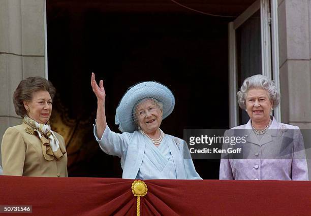 Britain's Queen Mother in blue hat and dress celebrating her 100th birthday w. Daughters Princess Margaret in brown and Queen Elizabeth II in...