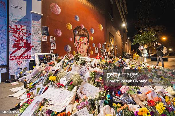 Flowers, letters and other tributes left on a mound continue to grow two weeks after the death of Brixton born English singer, songwriter David Bowie...