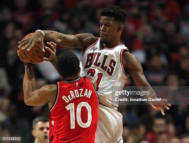 Jimmy Butler of the Chicago Bulls blocks a shot by DeMar DeRozan of the Toronto Raptors at the United Center on December 28, 2015 in Chicago,...