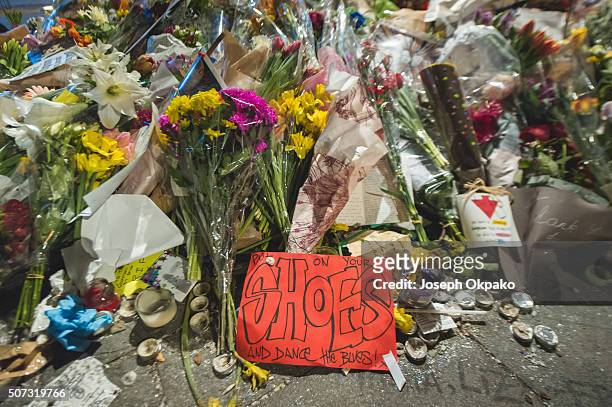 Close up details of Flowers, letters and other tributes left on a mound continue to grow two weeks after the death of Brixton born English singer,...