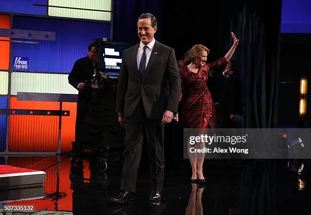 Republican presidential candidates Rick Santorum and Carly Fiorina walk on the stage prior to the Fox News - Google GOP Debate January 28, 2016 at...