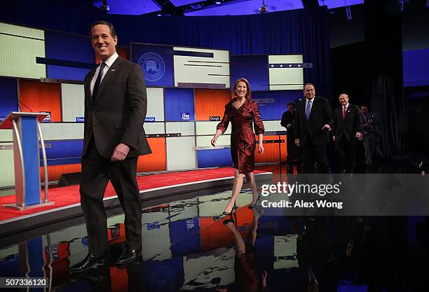 Republican presidential candidates Rick Santorum, Carly Fiorina, Mike Huckabee and Jim Gilmore walk on the stage prior to the Fox News - Google GOP...